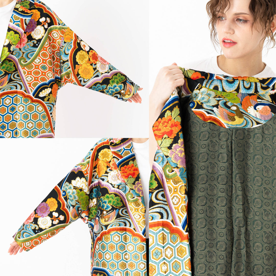 A woman is wearing an oversized silk coat for women. This long silk coat embodies the essence of a long coat for women. Its surface is adorned with intricate silk embroidery, exemplifying the artistry behind a silk embroidered coat for women. The coat's length accentuates its elegance, making it a perfect representation of a long embroidered coat. The oversized nature of this oversized coat for women adds a touch of grandeur to the ensemble, combining style and comfort seamlessly.