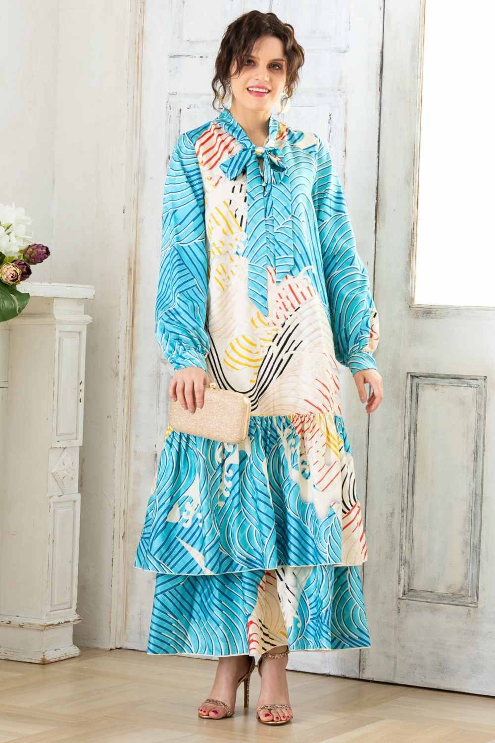 A woman is wearing a wedding guest dress which is also a silk wedding guest dress, showcasing her impeccable style in a stunning fall wedding guest outfit. This long-sleeve party dress, ideal for any special occasion, embodies elegance and sophistication, making her the epitome of grace and charm. Whether it's a tea party dress with delicate details or a chic cocktail dress that exudes confidence, her choice of wedding guest clothes reflects her fashion-forward sensibilities.