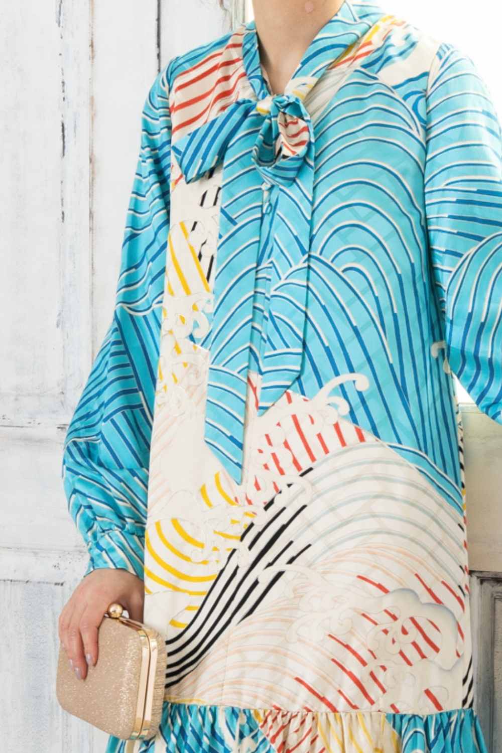 A woman is wearing a wedding guest dress which is also a silk wedding guest dress, showcasing her impeccable style in a stunning fall wedding guest outfit. This long-sleeve party dress, ideal for any special occasion, embodies elegance and sophistication, making her the epitome of grace and charm. Whether it's a tea party dress with delicate details or a chic cocktail dress that exudes confidence, her choice of wedding guest clothes reflects her fashion-forward sensibilities.