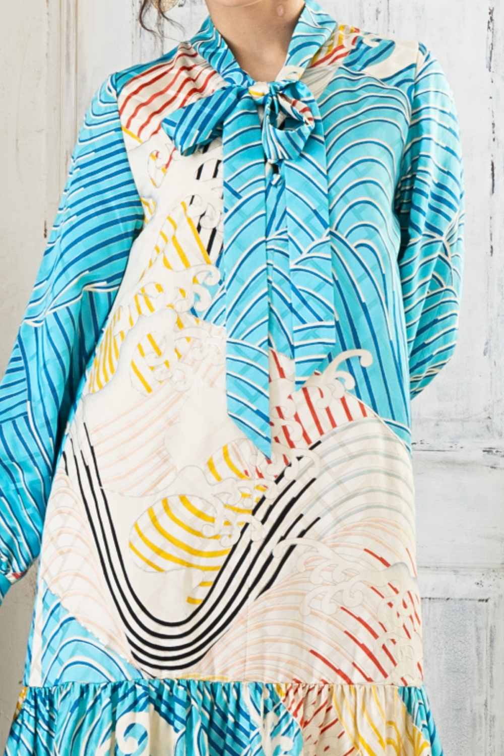 A woman is wearing a wedding guest dress which is also a silk wedding guest dress, showcasing her impeccable style in a stunning fall wedding guest outfit. This long-sleeve party dress, ideal for any special occasion, embodies elegance and sophistication, making her the epitome of grace and charm. Whether it's a tea party dress with delicate details or a chic cocktail dress that exudes confidence, her choice of wedding guest clothes reflects her fashion-forward sensibilities.