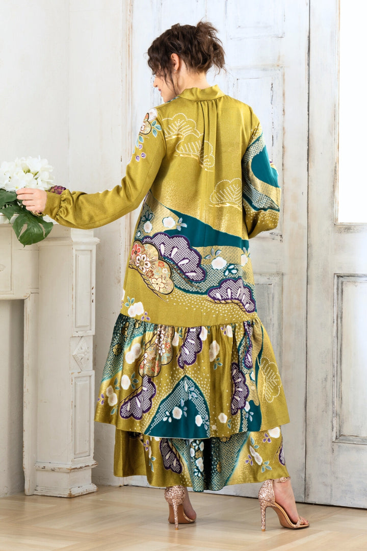 A woman is wearing a wedding guest dress which is also a silk wedding guest dress, showcasing her impeccable style in a stunning fall wedding guest outfit. This long-sleeve party dress, ideal for any special occasion, embodies elegance and sophistication, making her the epitome of grace and charm. Whether it's a tea party dress with delicate details or a chic cocktail dress that exudes confidence, her choice of wedding guest clothes reflects her fashion-forward sensibilities.