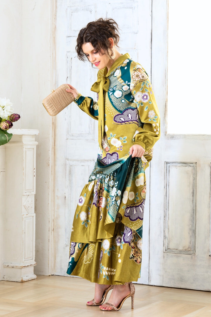 A woman is wearing a wedding guest dress which is also a silk wedding guest dress, showcasing her impeccable style in a stunning fall wedding guest outfit. This long-sleeve party dress, ideal for any special occasion, embodies elegance and sophistication, making her the epitome of grace and charm. Whether it's a tea party dress with delicate details or a chic cocktail dress that exudes confidence, her choice of wedding guest clothes reflects her fashion-forward sensibilities.