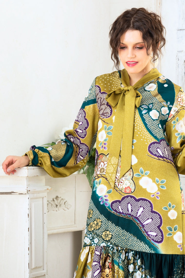 A woman is wearing a wedding guest dress which is also a silk wedding guest dress, showcasing her impeccable style in a stunning fall wedding guest outfit. This long-sleeve party dress, ideal for any special occasion, embodies elegance and sophistication, making her the epitome of grace and charm. Whether it's a tea party dress with delicate details or a chic cocktail dress that exudes confidence, her choice of wedding guest clothes reflects her fashion-forward sensibilities.