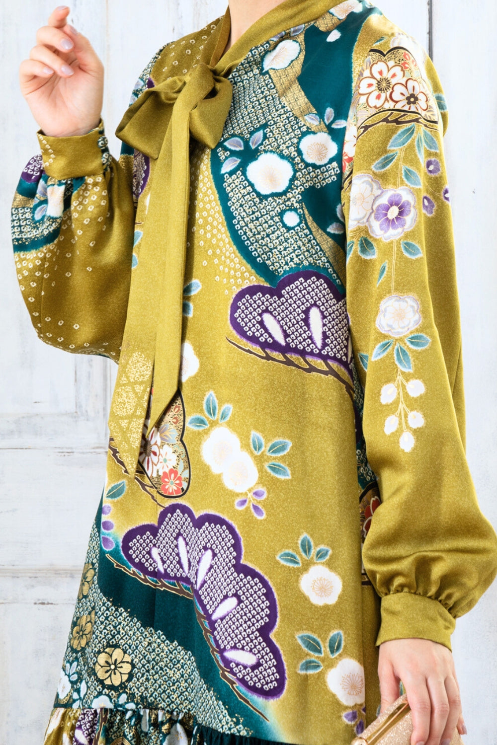 A woman is wearing a wedding guest dress which is also a silk wedding guest dress, showcasing her impeccable style in a stunning fall wedding guest outfit. This long-sleeve party dress, ideal for any special occasion, embodies elegance and sophistication, making her the epitome of grace and charm. Whether it's a tea party dress with delicate details or a chic cocktail dress that exudes confidence, her choice of wedding guest clothes reflects her fashion-forward sensibilities.