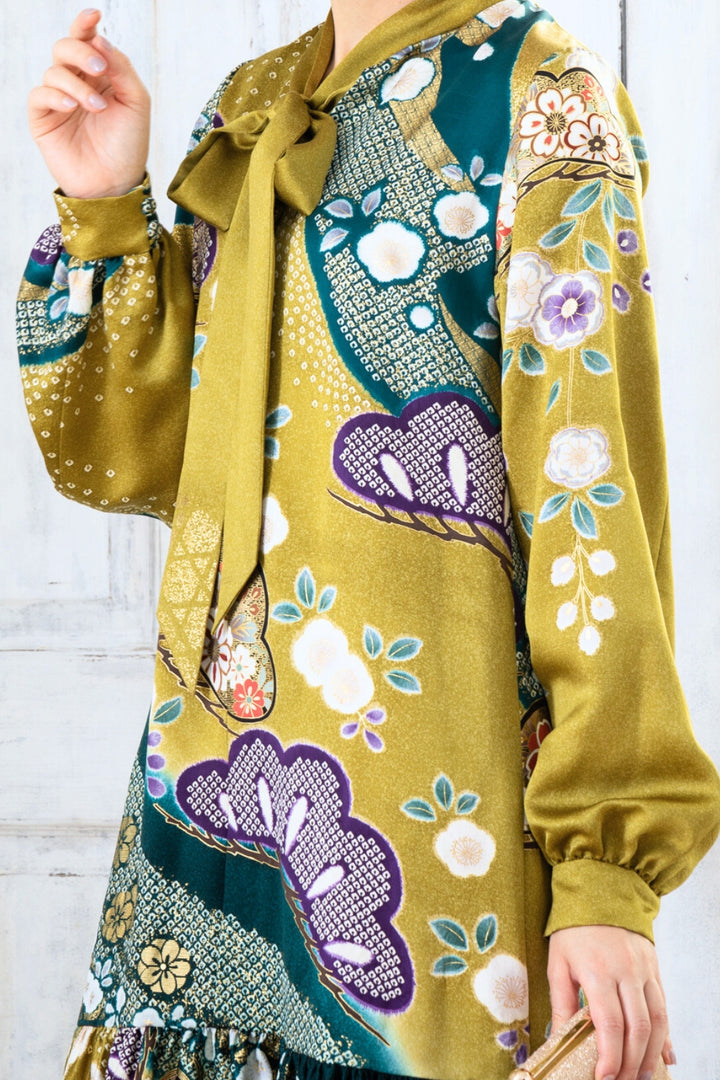 A woman is wearing a wedding guest dress which is also a silk wedding guest dress, showcasing her impeccable style in a stunning fall wedding guest outfit. This long-sleeve party dress, ideal for any special occasion, embodies elegance and sophistication, making her the epitome of grace and charm. Whether it's a tea party dress with delicate details or a chic cocktail dress that exudes confidence, her choice of wedding guest clothes reflects her fashion-forward sensibilities.