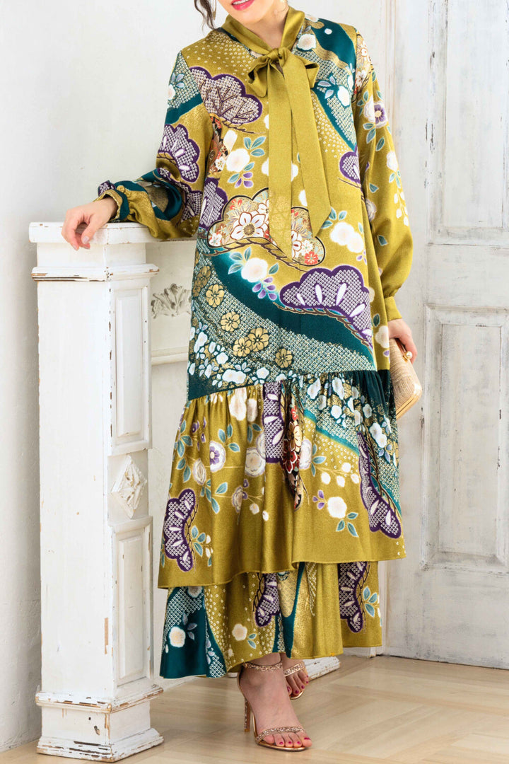 A woman is wearing a wedding guest dress which is also a silk wedding guest dress, showcasing her impeccable style in a stunning fall wedding guest outfit. This long-sleeve party dress, ideal for any special occasion, embodies elegance and sophistication, making her the epitome of grace and charm. Whether it's a tea party dress with delicate details or a chic cocktail dress that exudes confidence, her choice of wedding guest clothes reflects her fashion-forward sensibilities.