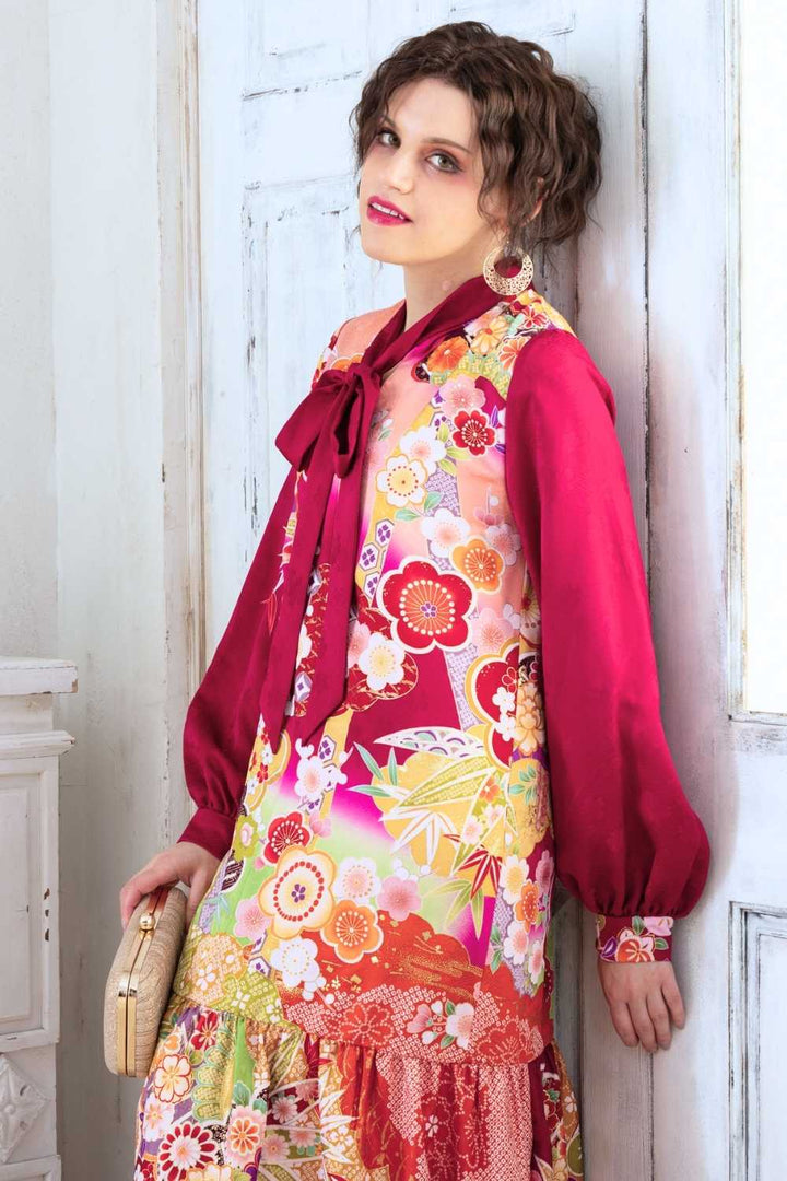 A woman is wearing a wedding guest dress which is also a silk wedding guest dress, showcasing her impeccable style in a stunning fall wedding guest outfit. This long-sleeve party dress, ideal for any special occasion, embodies elegance and sophistication, making her the epitome of grace and charm. Whether it's a tea party dress with delicate details or a chic cocktail dress that exudes confidence, her choice of wedding guest clothes reflects her fashion-forward sensibilities.