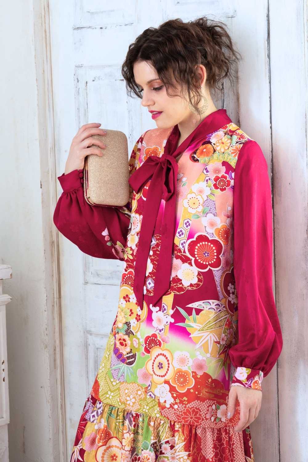 A woman is wearing a wedding guest dress which is also a silk wedding guest dress, showcasing her impeccable style in a stunning fall wedding guest outfit. This long-sleeve party dress, ideal for any special occasion, embodies elegance and sophistication, making her the epitome of grace and charm. Whether it's a tea party dress with delicate details or a chic cocktail dress that exudes confidence, her choice of wedding guest clothes reflects her fashion-forward sensibilities.