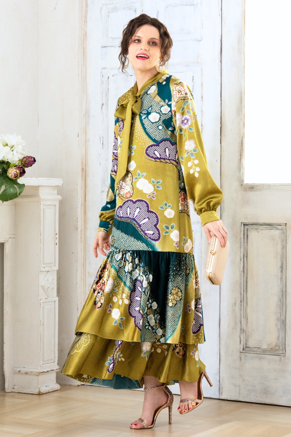 A woman is wearing a wedding guest dress which is also a silk wedding guest dress, showcasing her impeccable style in a stunning fall wedding guest outfit. This long-sleeve party dress, ideal for any special occasion, embodies elegance and sophistication, making her the epitome of grace and charm. Whether it's a tea party dress with delicate details or a chic cocktail dress that exudes confidence, her choice of wedding guest clothes reflects her fashion-forward sensibilities.