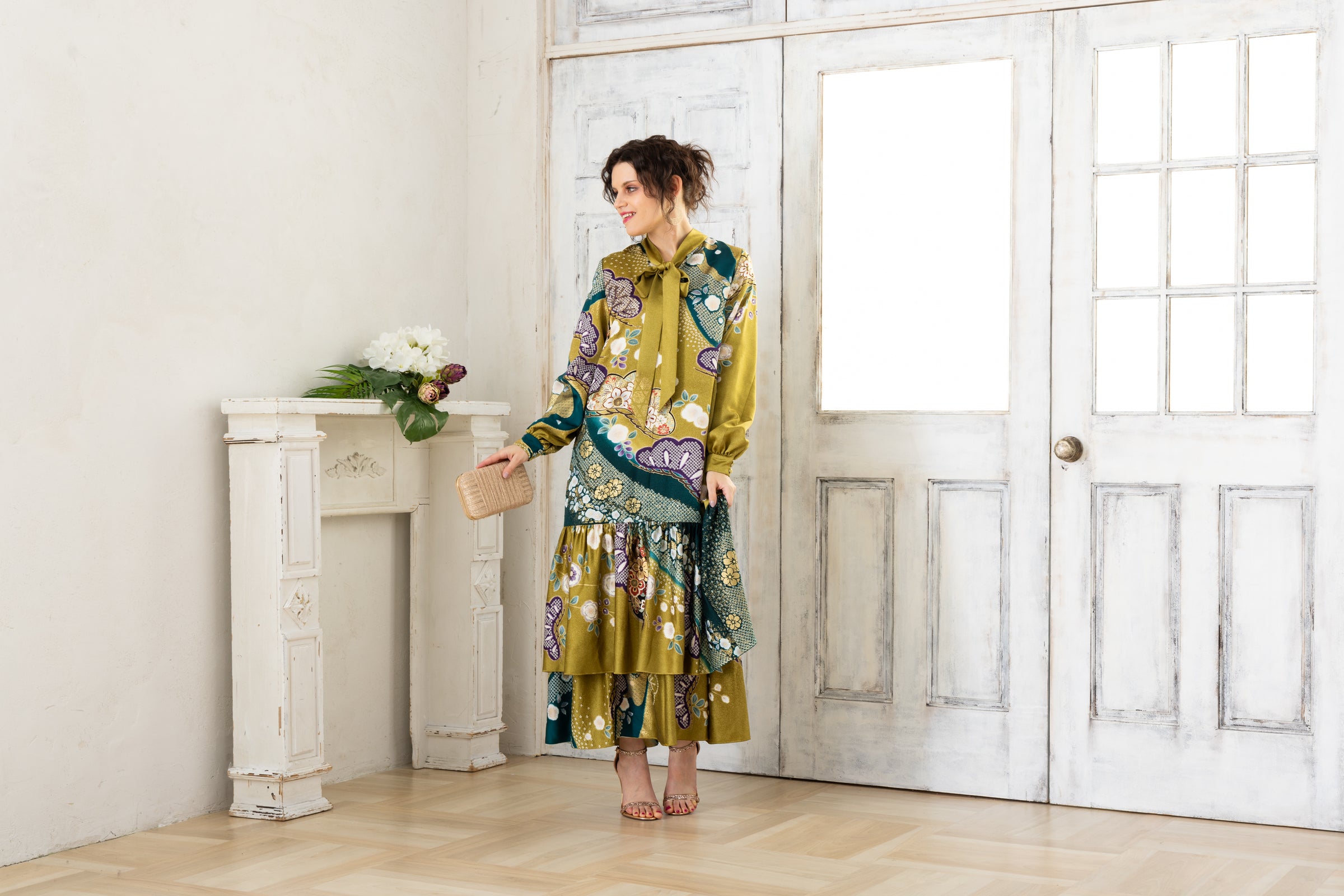 A woman is wearing a wedding guest dress, showcasing her impeccable style in a stunning fall wedding guest outfit. This long-sleeve party dress, ideal for any special occasion, embodies elegance