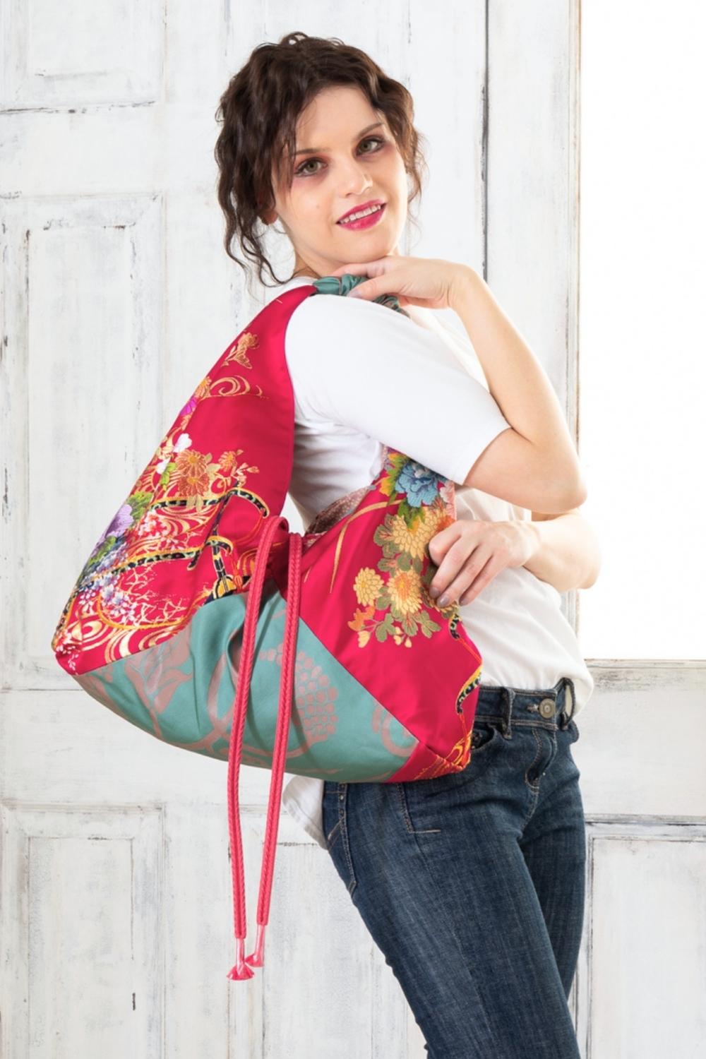 A pictue of a woman carrying a boho bag. With this oversized bag, she is making a bold fashion statement. The intricate details on this embroidered boho bag are a testament to its unique charm and the large boho bag trend. It's a vibrant accessory that elevates her style and captures attention wherever she goes.