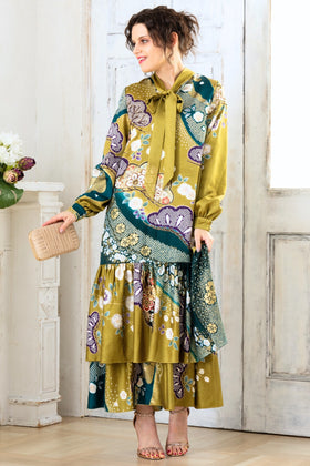  A woman is wearing a wedding guest dress which is also a silk wedding guest dress, showcasing her impeccable style in a stunning fall wedding guest outfit. This long-sleeve party dress, ideal for any special occasion, embodies elegance and sophistication, making her the epitome of grace and charm. Whether it's a tea party dress with delicate details or a chic cocktail dress that exudes confidence, her choice of wedding guest clothes reflects her fashion-forward sensibilities. 